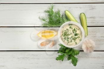 Composition with tartar sauce on white wooden background, top view�