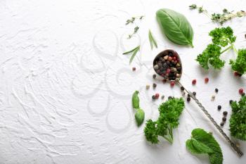 Composition with different fresh herbs and spices on light background�