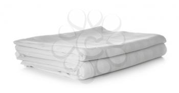 Stack of clean bed sheets on white background�