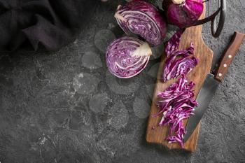 Board with cut red cabbage on grunge table�