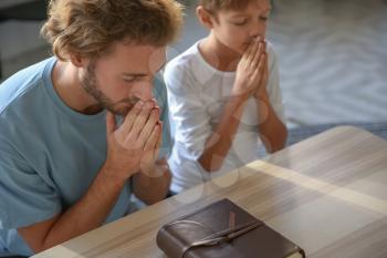 Father with son praying at home�