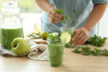 Jar of aloe vera cocktail on wooden table�