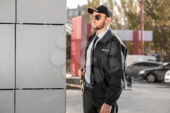Male security guard outdoors�