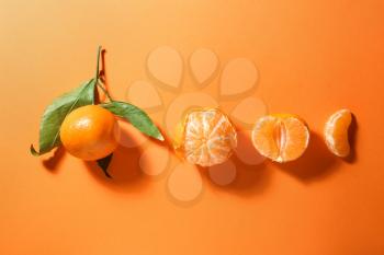 Tasty juicy tangerines on color background�