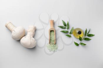 Spa composition with herbal bags on light background�