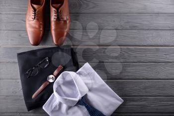 Stylish men's clothes with accessories on wooden background�