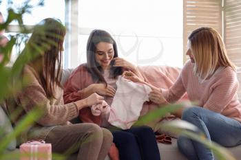 Pregnant woman with her friends at baby shower party�