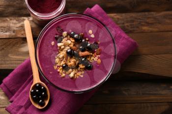 Bowl with tasty acai smoothie on wooden table�
