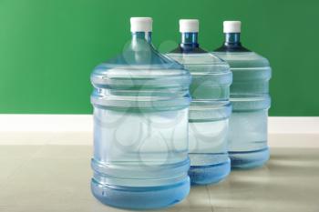 Bottles of fresh water on floor near color wall�