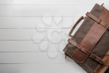 Male briefcase on white wooden background�