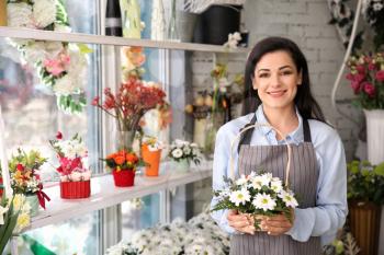 Beautiful female owner in flower shop�