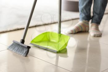 Beautiful woman cleaning floor at home�