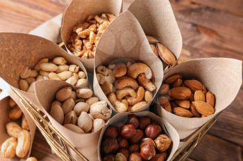 Basket with assortment of tasty nuts on table�