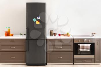 Big modern fridge in interior of kitchen�