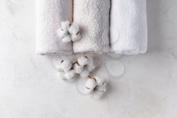 Cotton flowers with soft towels on light table�