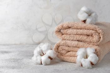 Cotton flowers with soft towels on light table�