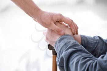 Caregiver with senior man in nursing home, closeup�