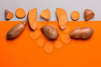 Fresh sweet potatoes on color background�