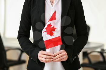 Woman with Canadian flag indoors�