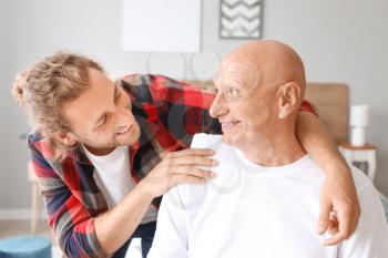 Young man visiting his father in nursing home�