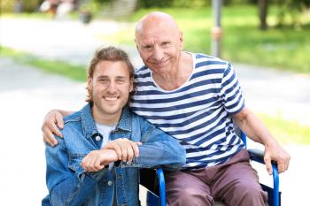 Elderly man with his son in park�