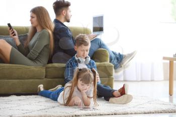 Family addicted to modern technologies with devices at home�