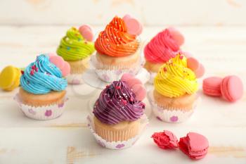 Sweet tasty cupcakes on light table�