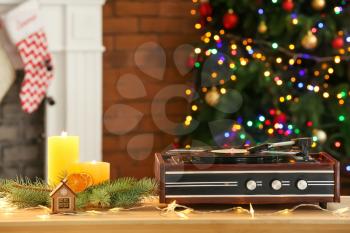 Record player and Christmas decor on table�