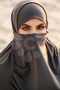 Portrait of beautiful Muslim woman outdoors�