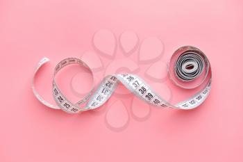 Measuring tape on color background�