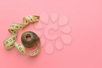 Measuring tape on color background�
