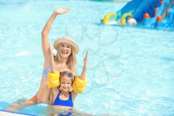 Woman with her little daughter resting in aqua park�