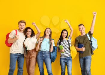 Group of happy students on color background�