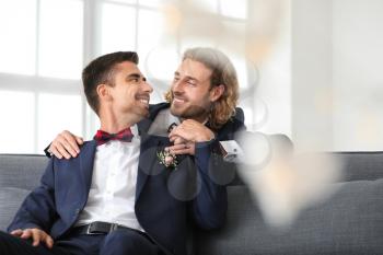 Happy gay couple on their wedding day at home�