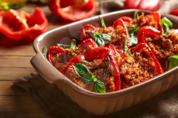Baking dish with tasty stuffed pepper on table�