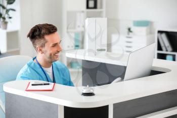 Male receptionist working in clinic�