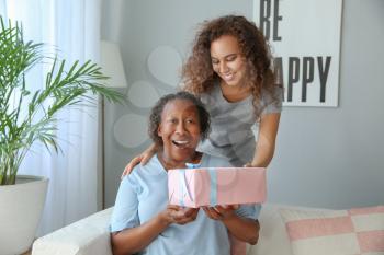 Portrait of African-American woman greeting her mother at home�