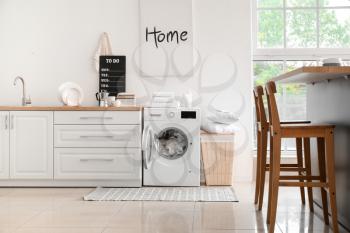 Interior of kitchen with modern washing machine�