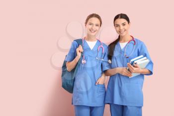 Female medical students on color background�