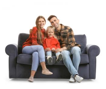 Happy young family sitting on sofa against white background�