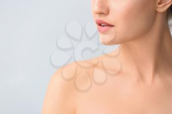 Beautiful young woman on light background, closeup. Concept of plastic surgery�