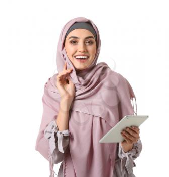 Beautiful Arab woman with tablet computer on white background�