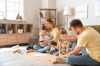 Family assembling furniture at home�