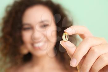 Young woman with fish oil, closeup�