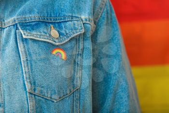 Person with pinned rainbow badge as a symbol of LGBT, closeup�