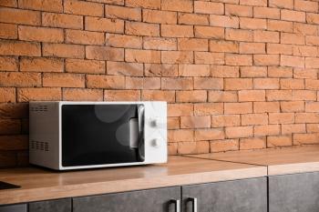 Modern microwave oven in kitchen�