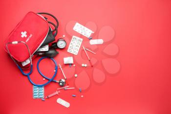 First aid kit on color background�