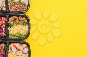 Containers with healthy food on color background�