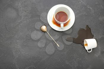 Cups and spilled coffee on grey background�