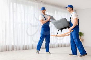 Loaders carrying furniture in flat�